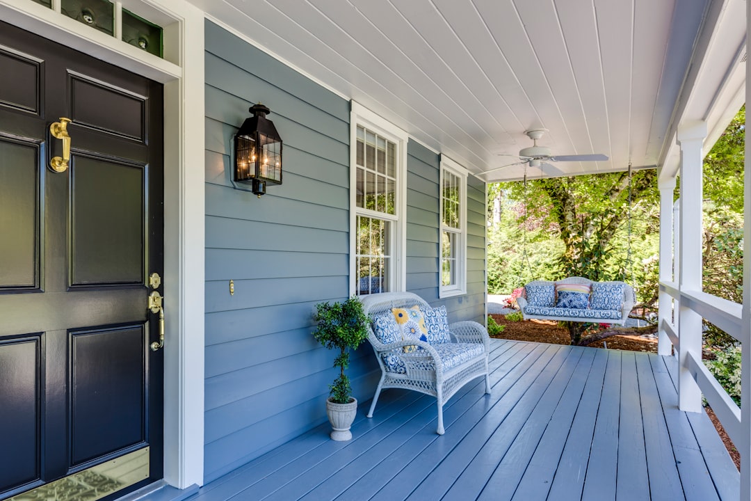 a-porch-with-two-chairs-and-a-table-on-it-xcvm8mn7num